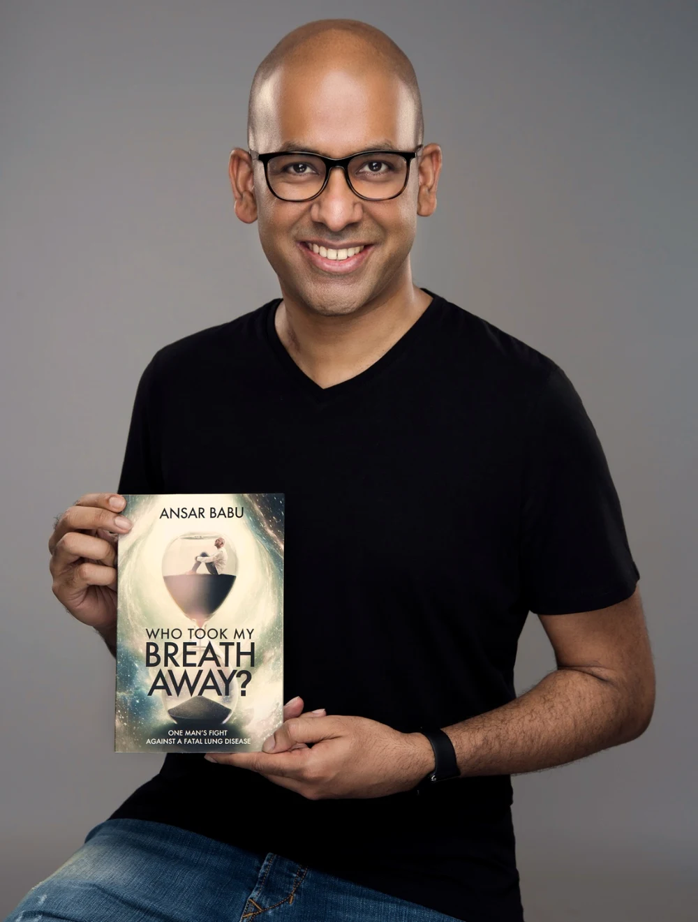 Ansar Babu holding a copy of Who Took My Breath Away?